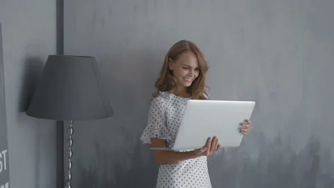 Cute girl with laptop computer having video call at home Stock Footage 88485617