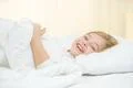 The cute girl lay on the bed Photo