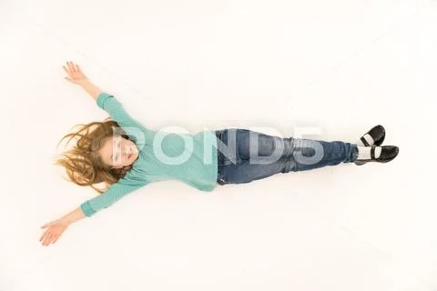 The cute girl lay on the floor. View from above Stock Photos