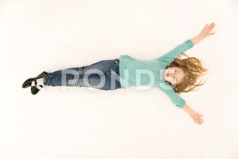The cute girl lay on the floor. View from above Stock Photos