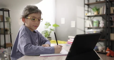 Cute girl learning online using digital tablet at virtual lesson class, making Stock Footage 267037845