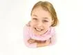 The cute girl look to the camera. View from above Photo