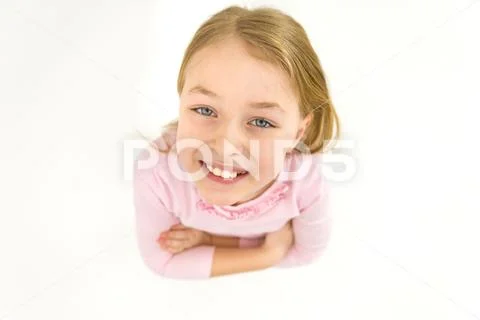 The cute girl look to the camera. View from above Stock Photos