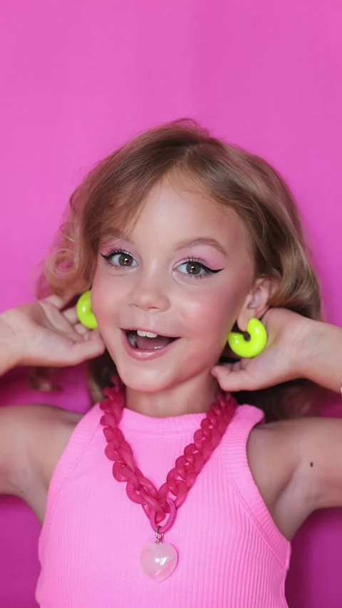 Cute girl make-up on camera, in pink clothes on pink background, little blogger Stock Footage 247416182