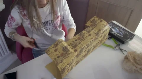 Cute girl makes a nice package for gift Video stock 61509583