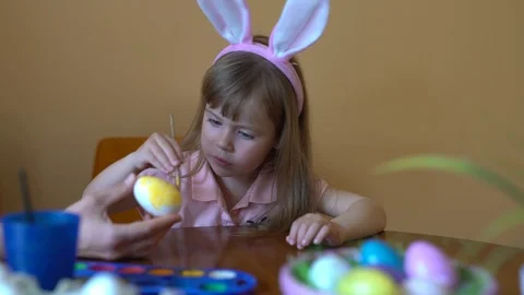 Cute girl paints an Easter egg. Stock Footage 105055359
