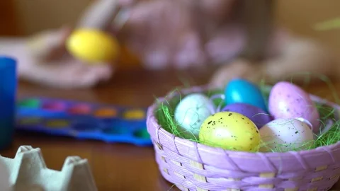 Cute Girl Paints An Easter Egg. Mom Helps Her Daughter To Draw On The Egg Stock Footage 105092254