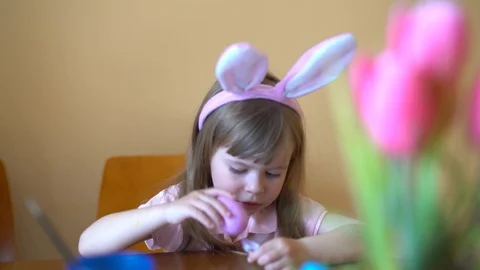 Cute Girl Paints An Easter Egg. Mom Helps Her Daughter To Draw On The Egg Stock Footage 105095017