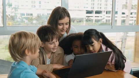 Cute girl programing system while surround with teacher and friend. Erudition. Stock Footage 261654565