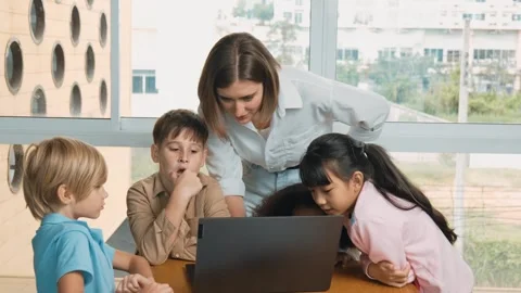 Cute girl programing system while surround with teacher and friend. Erudition. Stock Footage 266452856