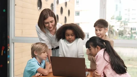 Cute girl programing system while surround with teacher and friend. Erudition. Stock Footage 270499134