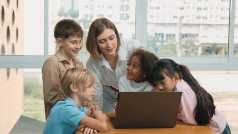 Cute girl programing system while surround with teacher and friend. Erudition. Stock Footage 273252348