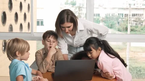 Cute girl programing system while surround with teacher and friend. Erudition. Stock Footage 277027738