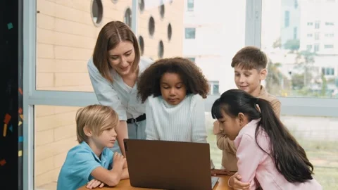 Cute girl programing system while surround with teacher and friend. Erudition. Video stock 279938918