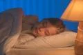 The cute girl sleeping on the bed. Evening night time Photo