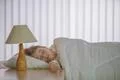 The cute girl sleeping on the bed with white linens Photo
