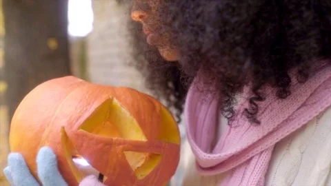 Cute girl smiling to Jack o'lantern Stock Footage 70544121