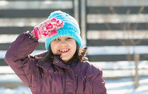 Cute girl standing still and saluting. Stock Photos