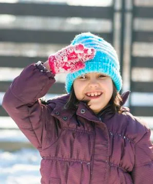Cute girl standing still and saluting. Stock Photos