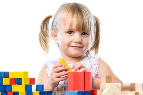 Cute girl at table playing educational game. Stock Photos