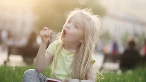Cute girl thinks questioningly and finding solution idea while write homework Stock Footage 242031261