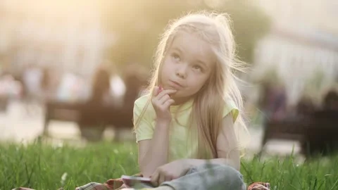 Cute girl thinks questioningly and finding solution idea while write homework Stock Footage 242031783