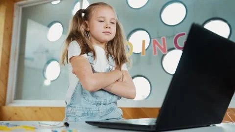 Cute girl using laptop programing software while looking at camera. Erudition. Stock Footage 264151874