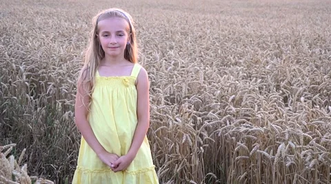 Cute girl in wheat field Stock Footage