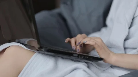 Cute girl working on a laptop while at home sitting in the chair. Hands close-up Stock Footage 71222429