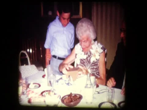 Cute grandson gives grandparents funny Anniversary present Stock Footage