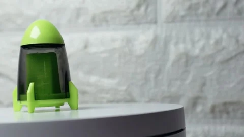 Cute green rocket-shaped pencil sharpener spinning on a white surface, show.. Stock Footage 297151551