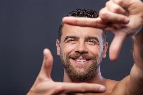 Cute guy with beard is gesturing positively 스톡 사진