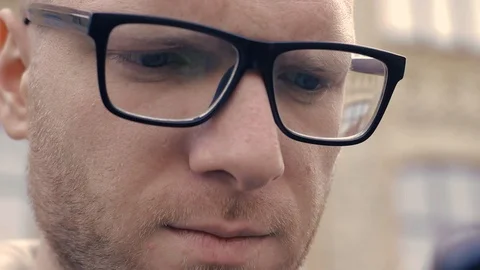 Cute guy leafing through the site on a smartphone Video stock 98368593