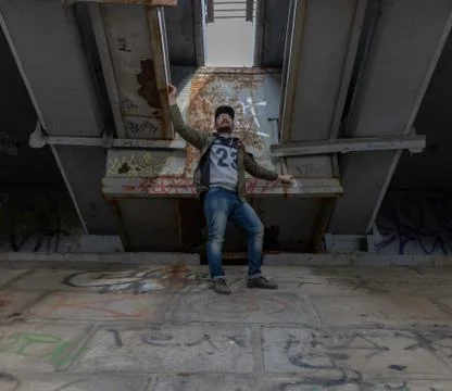 Cute guy stands on an overpass under the bridge. Stock Photos