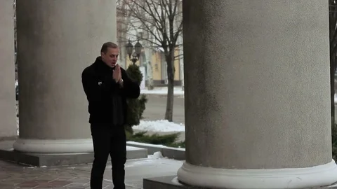 Cute guy waiting for someone. He was cold and dancing. Stock Footage 70871623