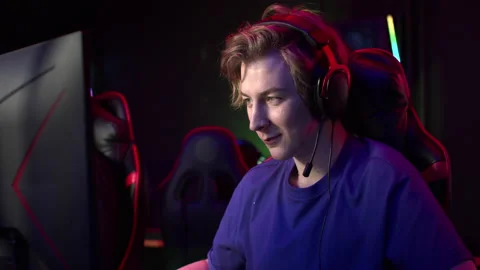 A cute guy watched a live stream on the computer, took off his headphones Stock Footage 152800439