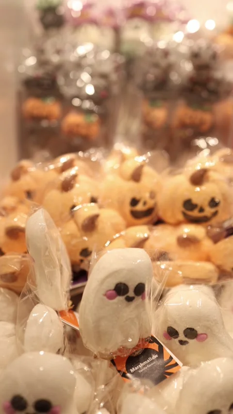 Cute Halloween ghost and pumpkin sweets displayed for seasonal celebration Stock Footage 345598771