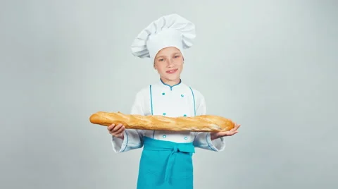 Cute happy baker girl child sniffing bread baguette isolated on white smiling Stock Footage