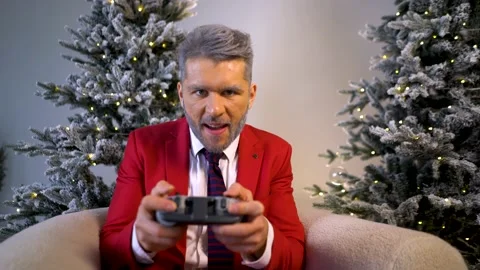 Cute happy santa looking at camera playing game console. Video stock 167650194