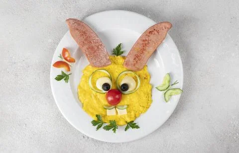 Cute hare made from scrambled eggs, sausage, cheese, tomato, cucumber and b.. Stock Photos