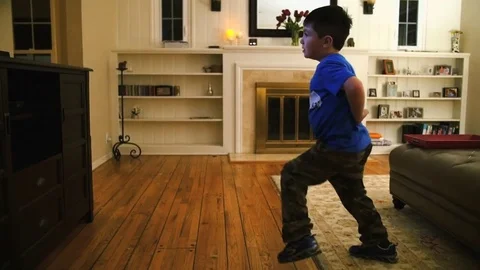 CUTE HISPANIC BOY DANCES IN LIVING ROOM SLO-MO Stock Footage 74930486
