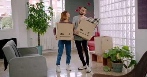 Cute Hispanic couple just moved to new home place and standing in light living Stock Footage 123667515
