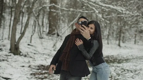 Cute hispanic latin couple doing selfie in the snow park Stock-Footage 88066324