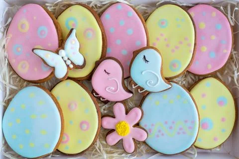 Cute holiday colourful Easter cookies laying inside of white gift box Stock Photos