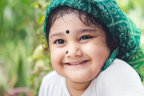 Cute Indian baby girl with traditional Indian dress with bindi on her forehea Stock Photos