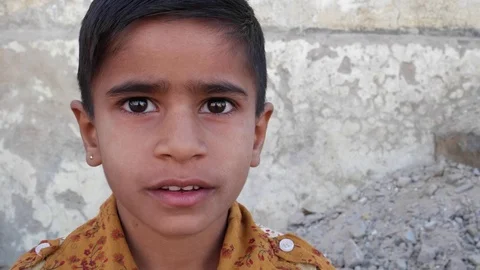 Cute Indian boy looking at the camera, closeup Stock Footage 69863406