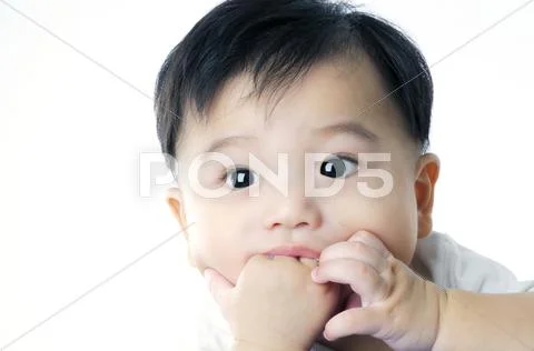Cute infant baby sucking his hand Stock Photos