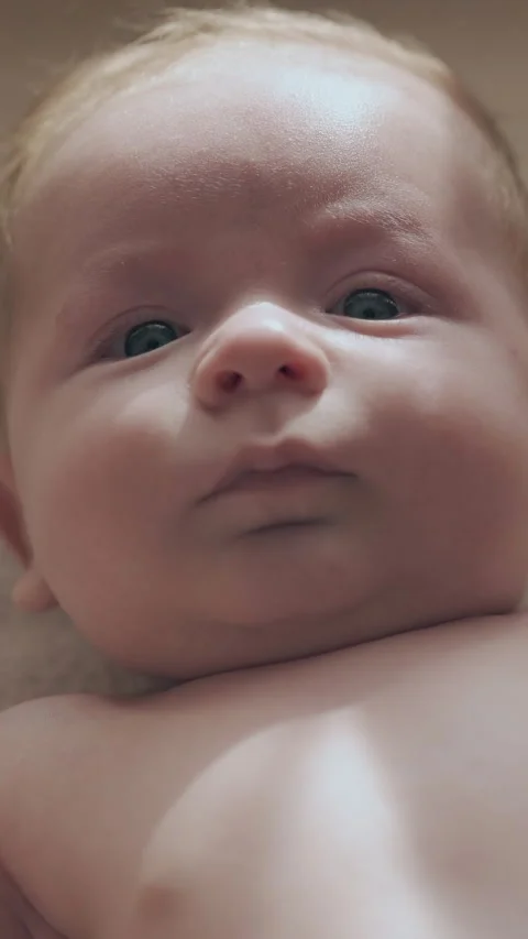 Cute infant boy with short blond hair and big blue eyes Stock Footage 317630623