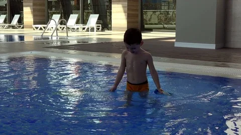 Cute kid bathes in the pool Stock Footage 73427657