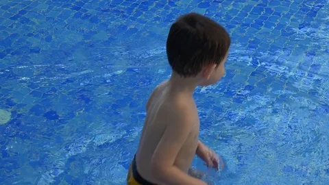 Cute kid bathes in the pool Video stock 73431514